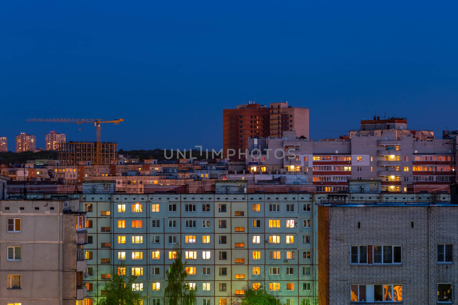 Windows, roofs and facade of an mass apartment buildings in Russia at evening