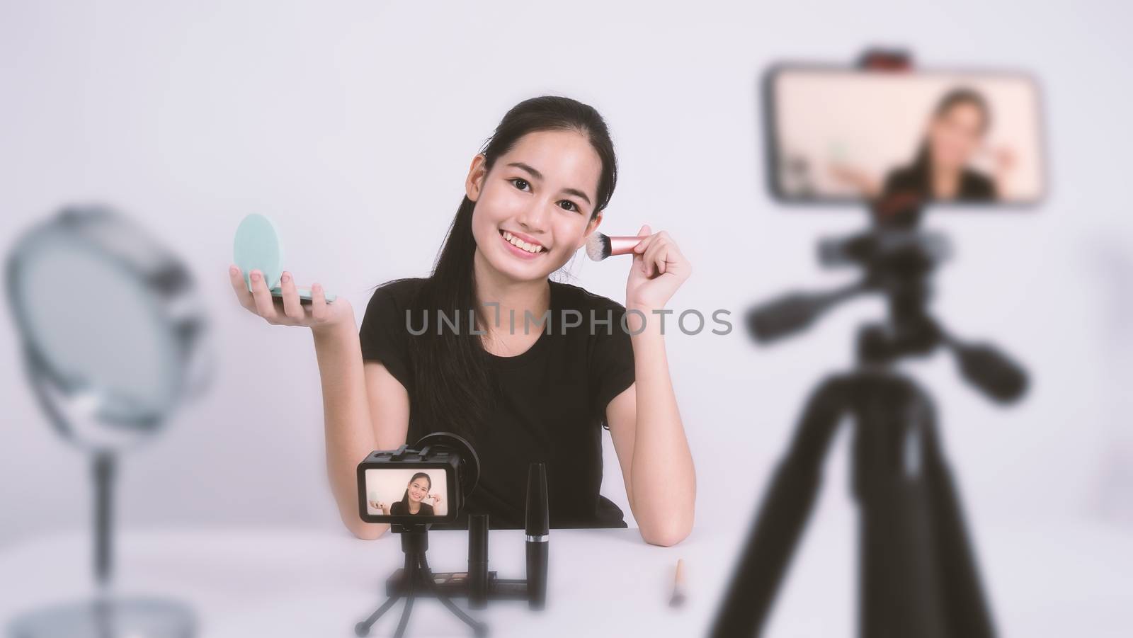 Asian teen woman sit in front of camera and live broadcasting by gnepphoto