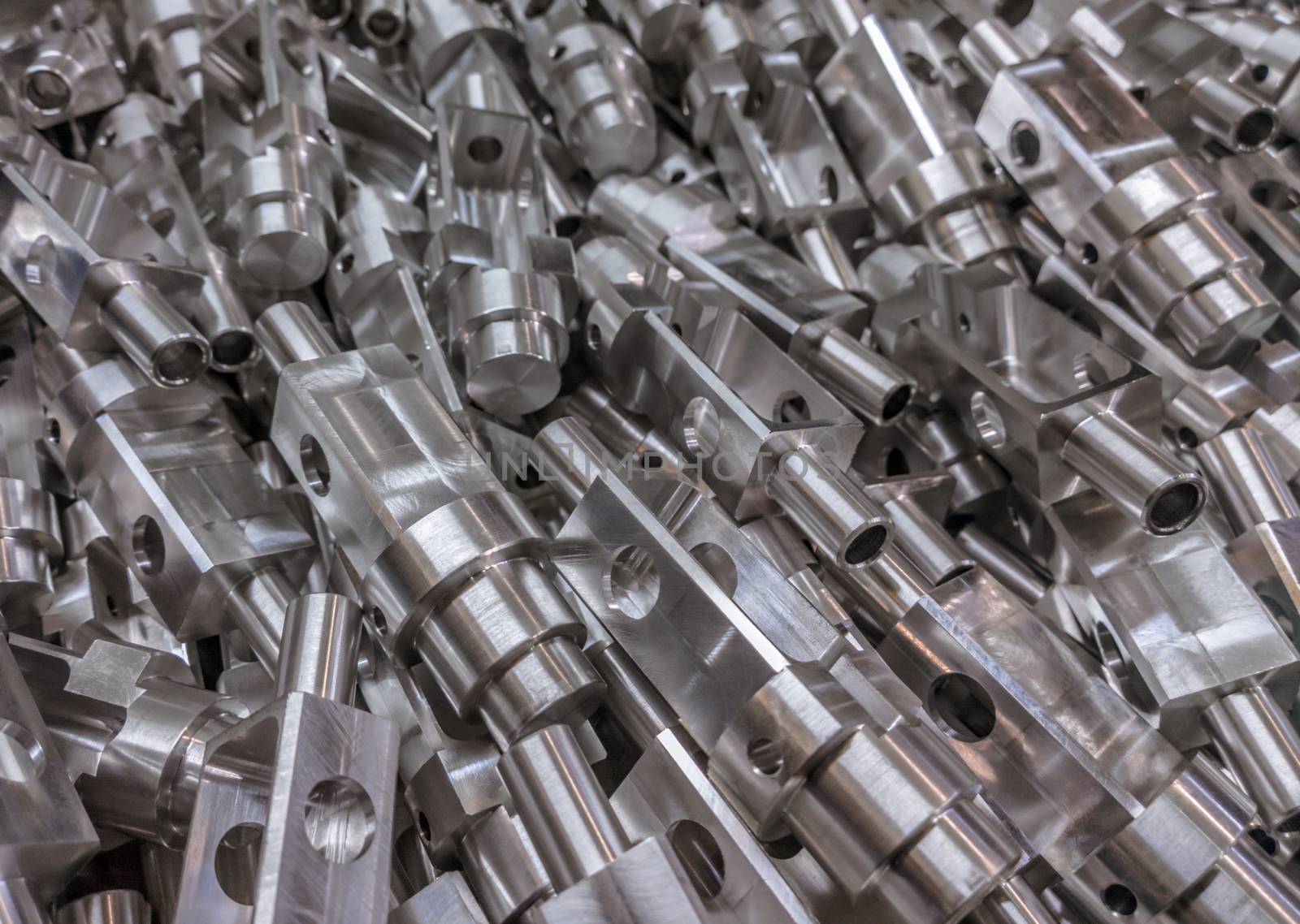 Shiny aluminium cnc machined parts background with selective focus close up technique.