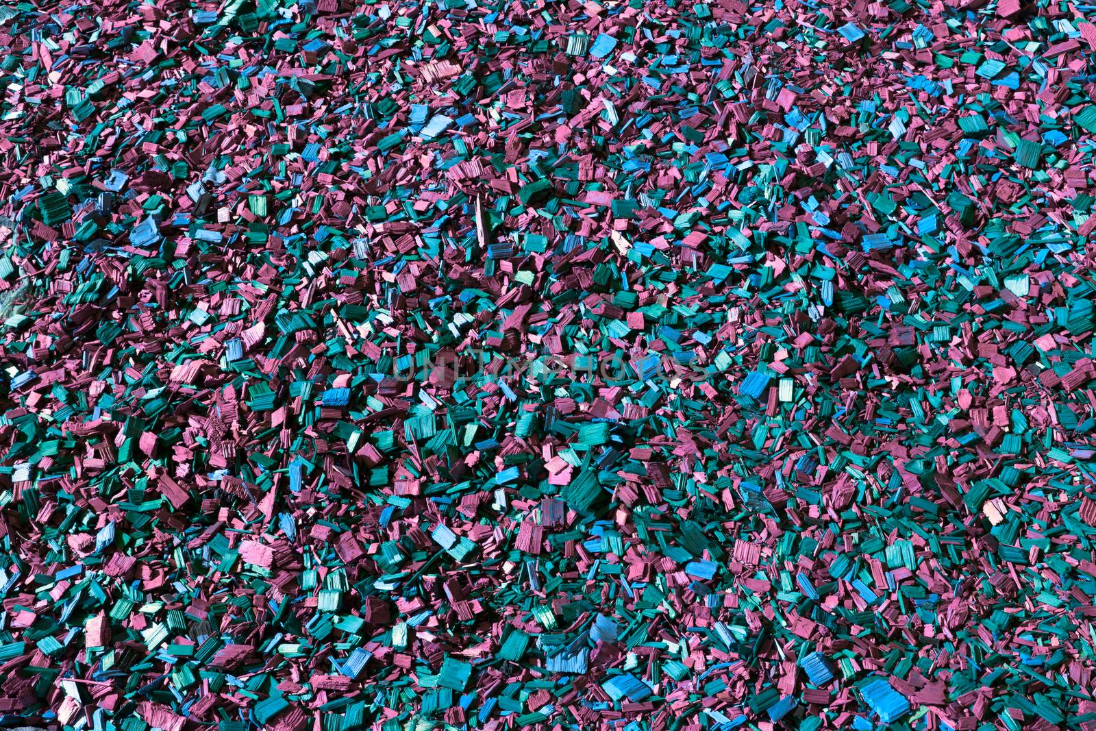 Colored wooden sawdust pieces texture close-up background