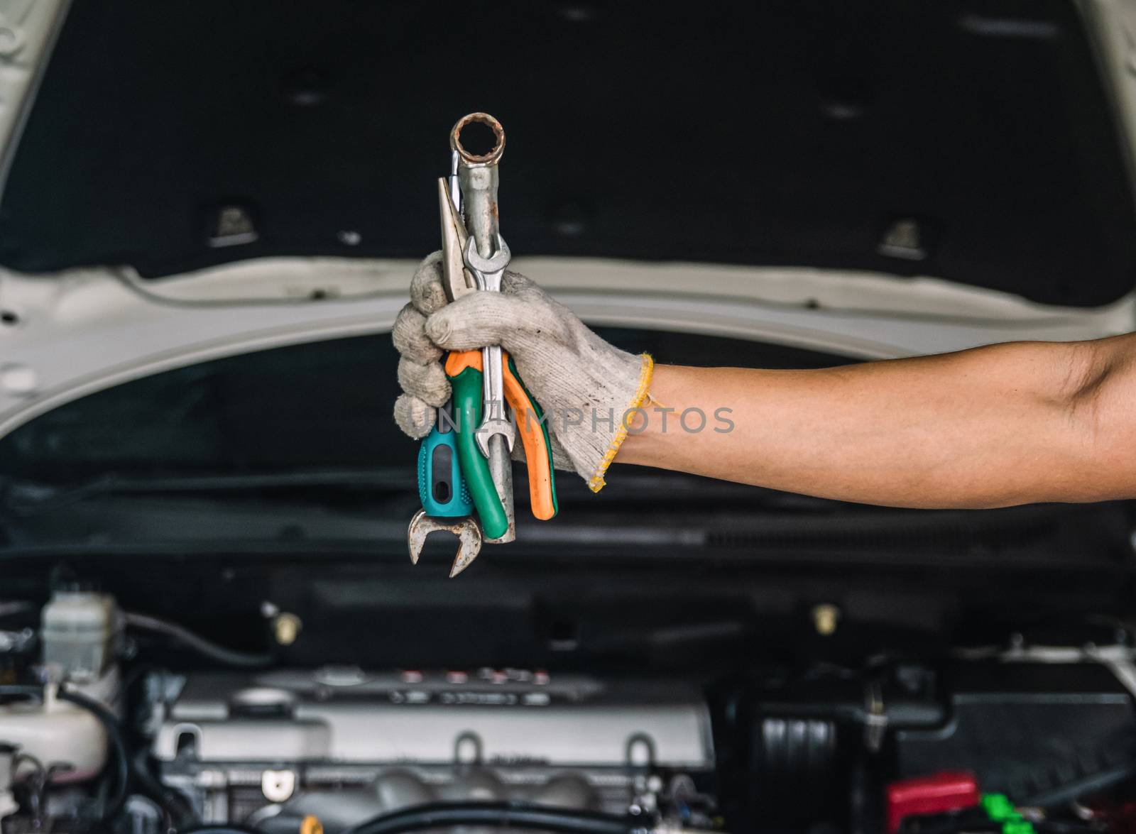 Hand of car mechanic with wrench auto mechanic Repair maintenance and car inspection