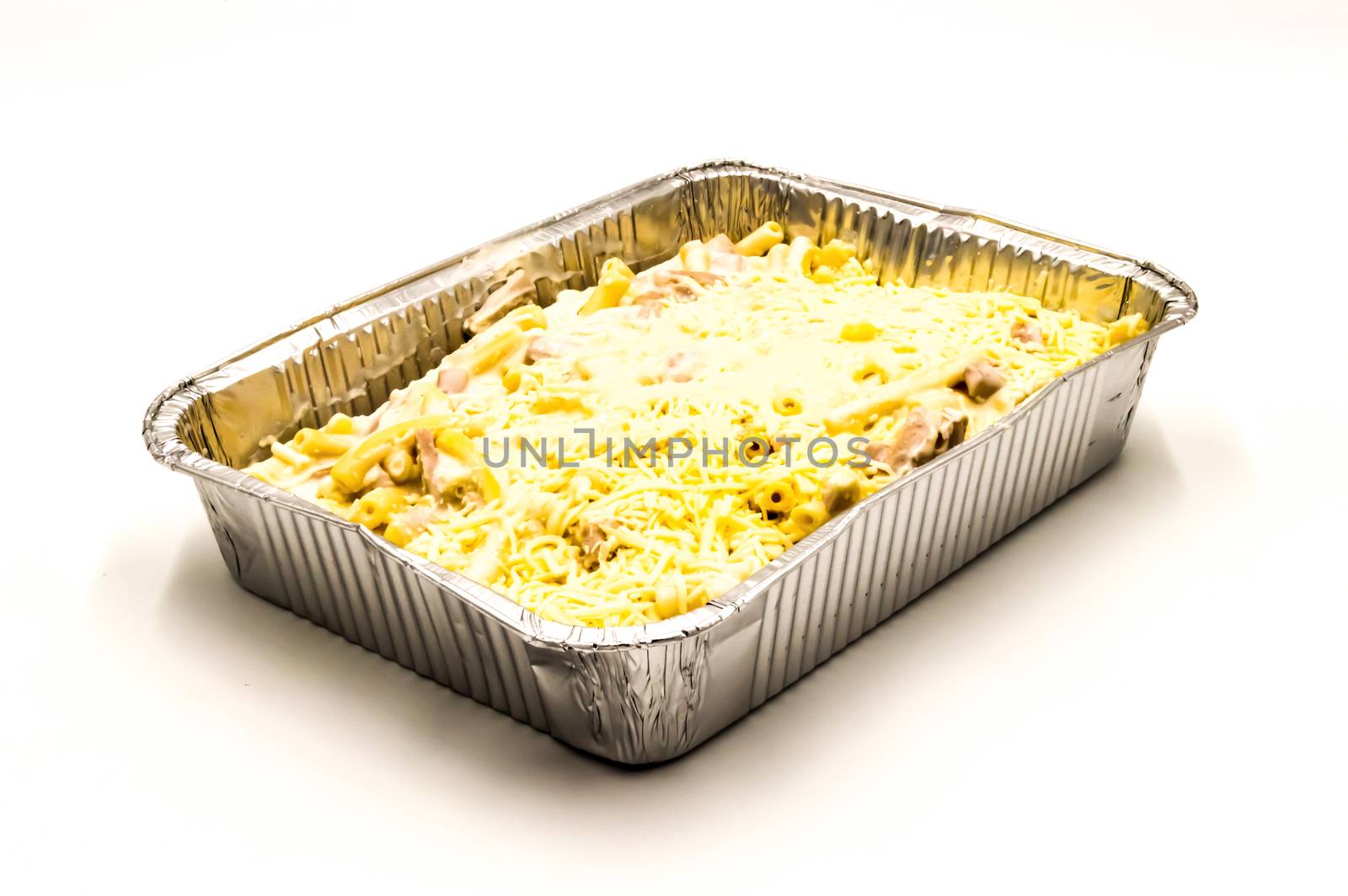 Pasta au gratin in an aluminum dish on a white background