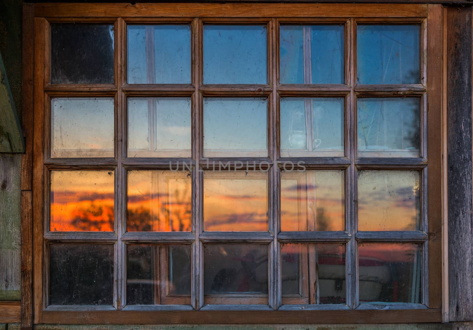 dirty wooden window with blurry sundown reflection, flat normal view