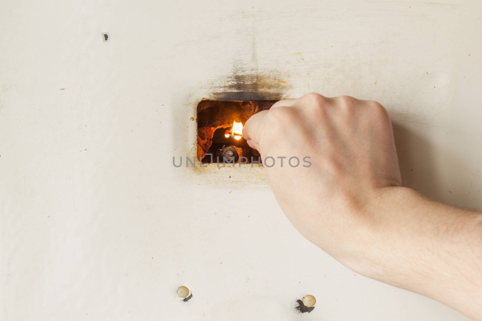 Manually firing up old russian gas water heater with flat front panel