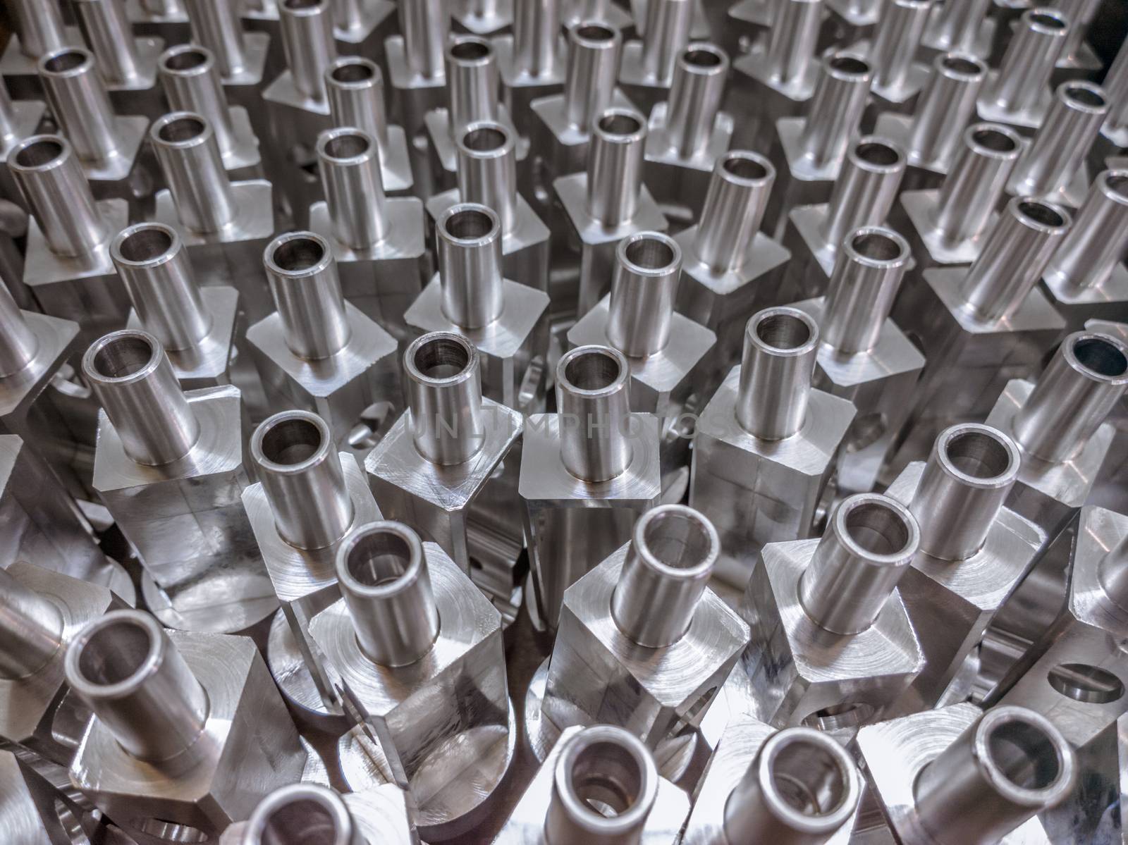 Shiny aluminium cnc machined parts background with selective focus close up technique.