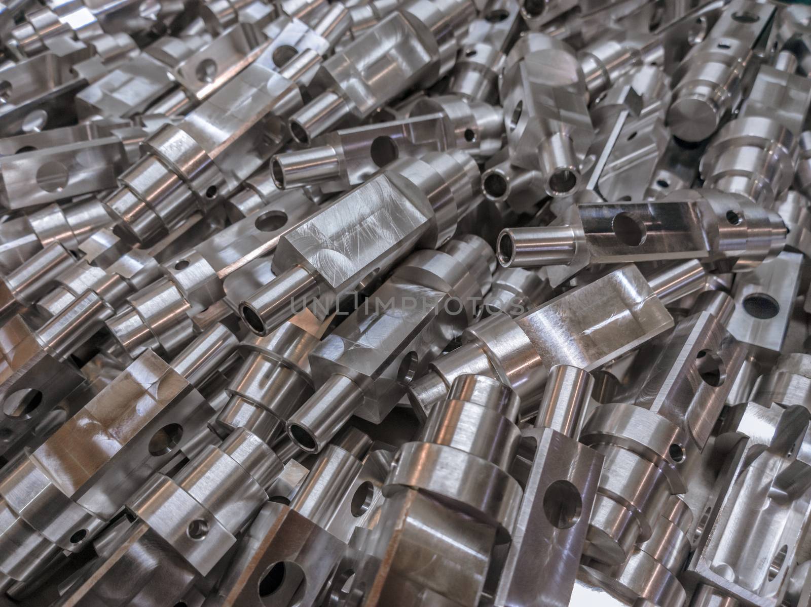 Shiny aluminium cnc machined parts background with selective focus close up technique.