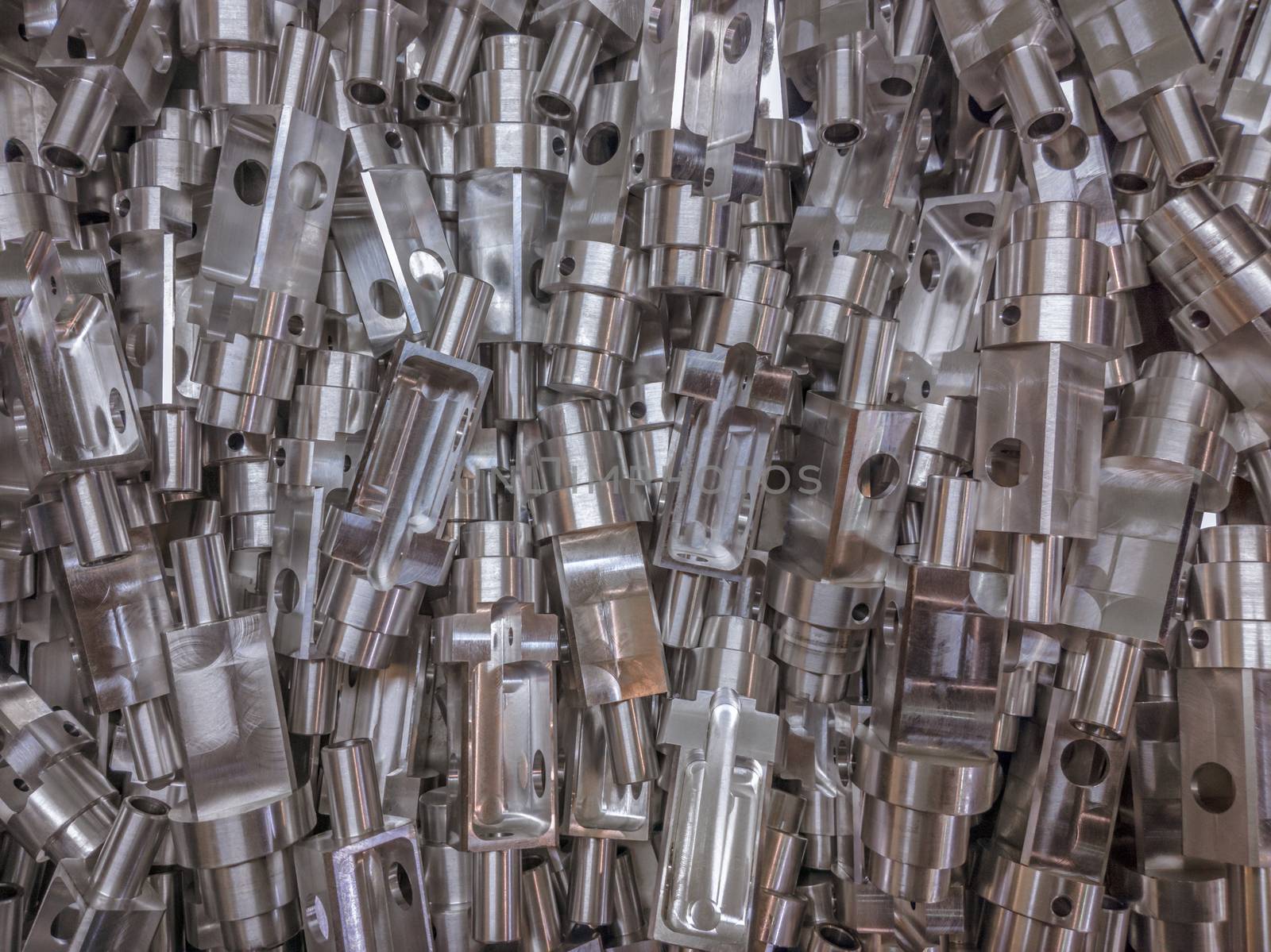 Shiny aluminium cnc machined parts flat background.