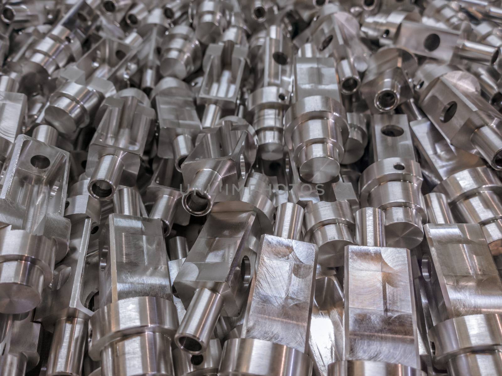 Shiny aluminium cnc machined parts background with selective focus close up technique.
