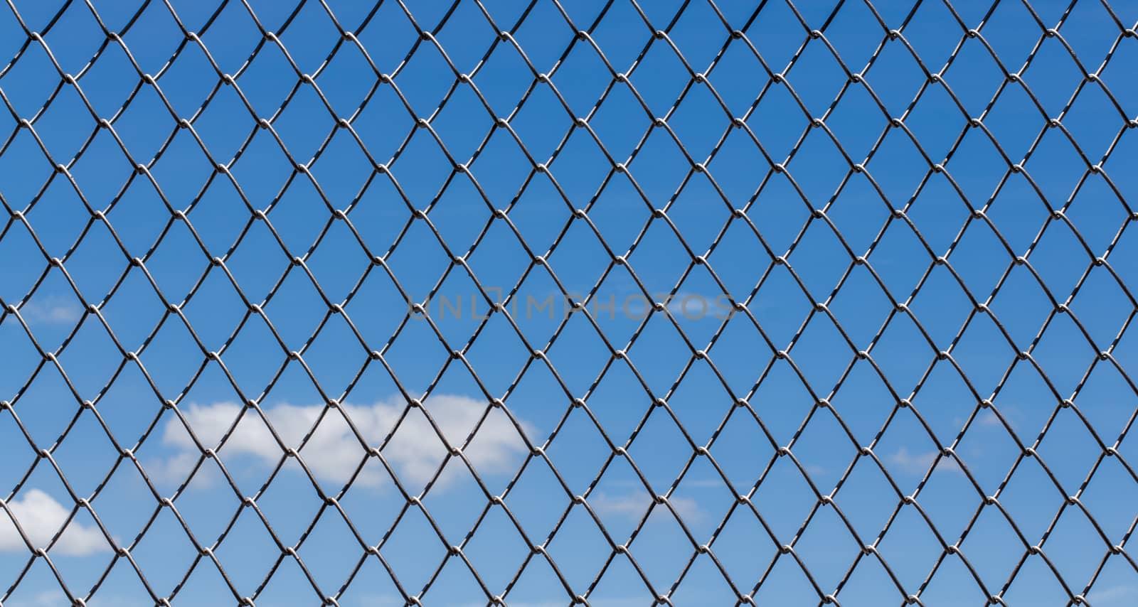 Metal mesh and sky by Praphan