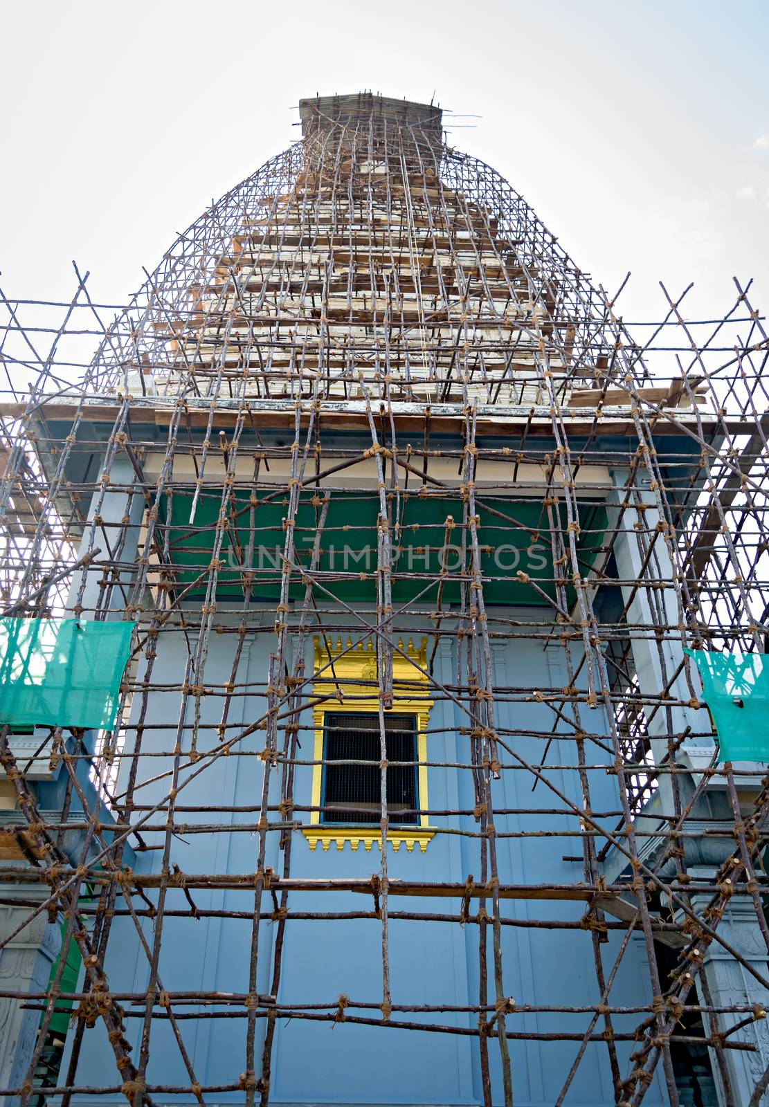 South Indian Temple covered with bamboo cage erected for painting work. by lalam