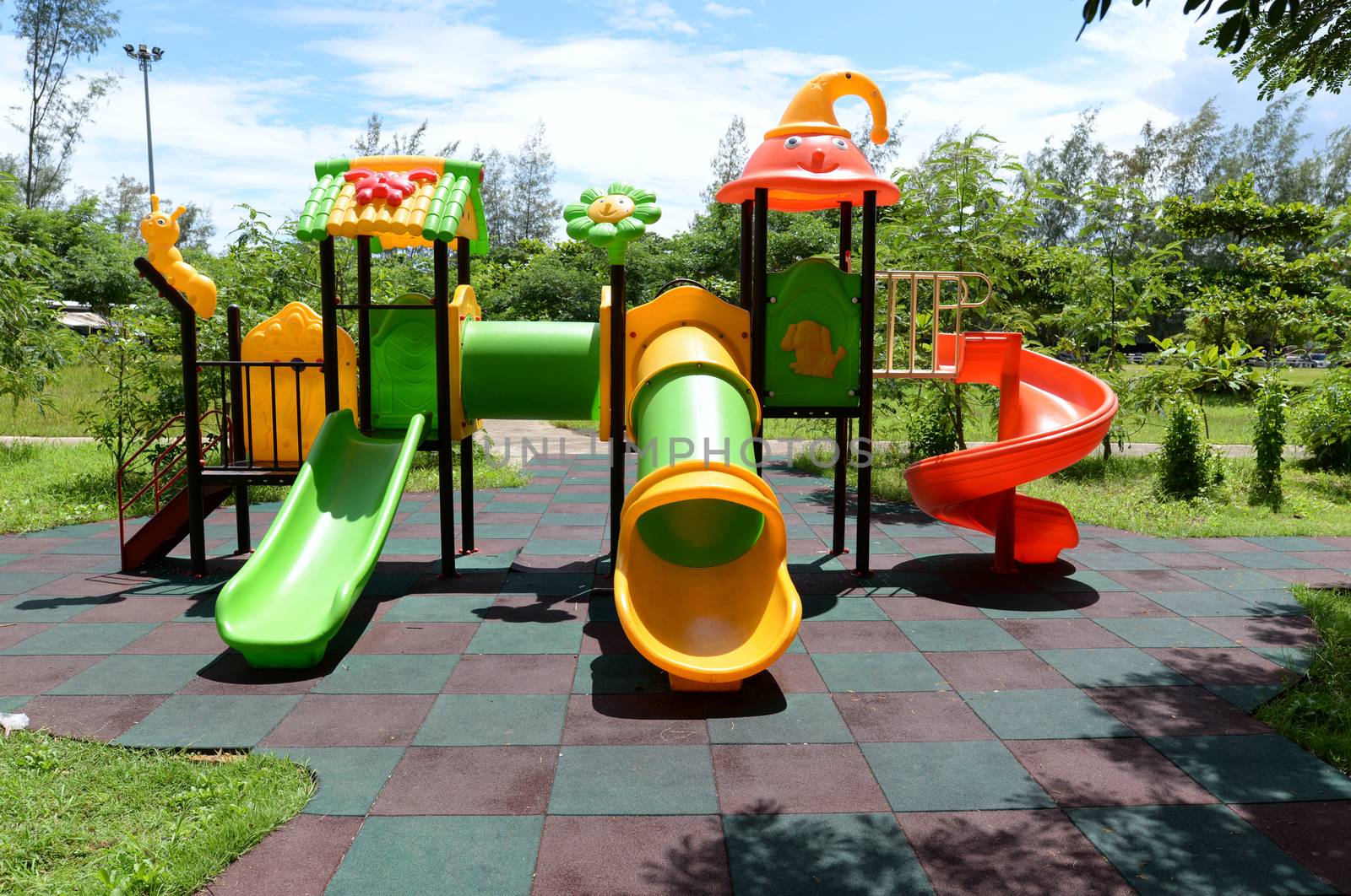 Colorful outdoor children playground in the park by hellogiant
