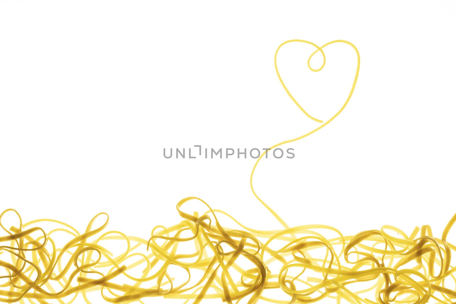 Swirls of cooked spaghetti with fork. Spaghetti heart shape
