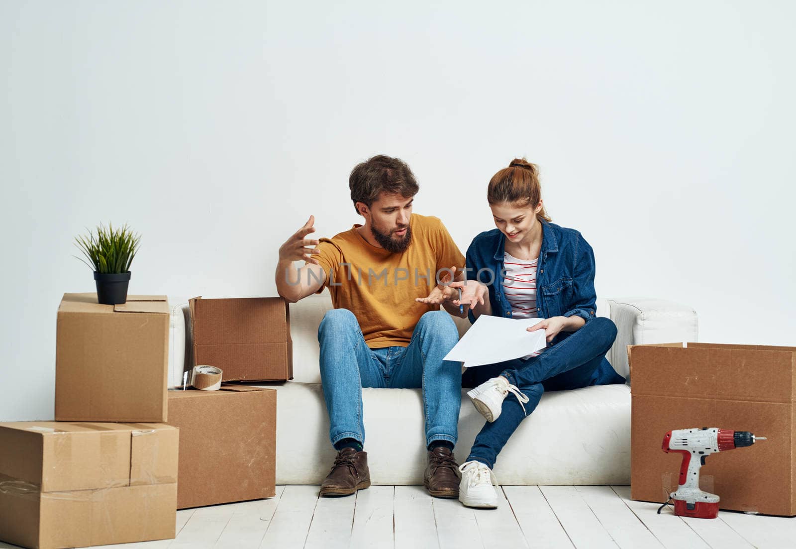 Man and woman in new room stuff in boxes moving family interior. High quality photo