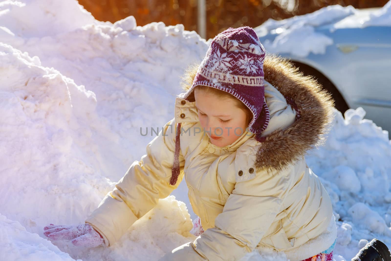 Cute little caucasian girl playing in the snow in winter by ungvar