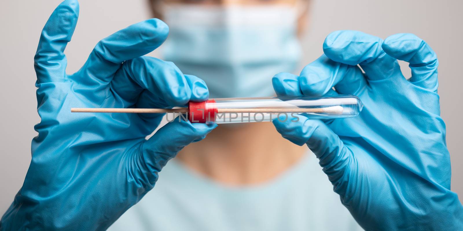 Medical healthcare nurse holding Coronavirus COVID-19 swab test kit, PPE protective mask and gloves, tube for taking OP NP patient specimen sample, PCR DNA RNA testing protocol process stock photo