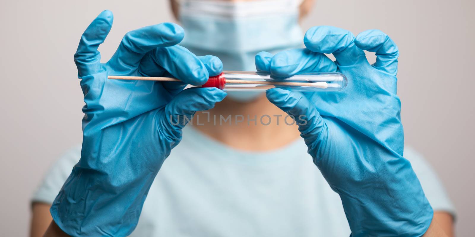 Medical healthcare nurse holding Coronavirus COVID-19 swab test kit, PPE protective mask and gloves, tube for taking OP NP patient specimen sample, PCR DNA RNA testing protocol process stock photo