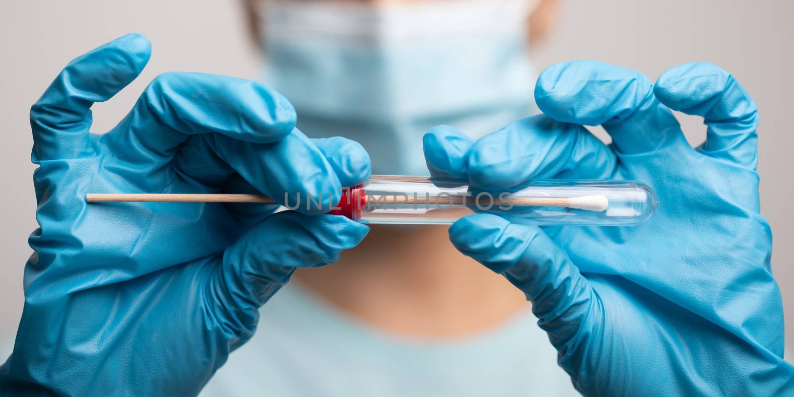 Medical healthcare nurse holding Coronavirus COVID-19 swab test kit, PPE protective mask and gloves, tube for taking OP NP patient specimen sample, PCR DNA RNA testing protocol process stock photo