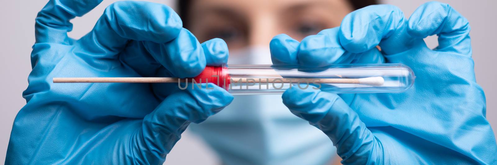 Medical healthcare nurse holding Coronavirus COVID-19 swab test kit, PPE protective mask and gloves, tube for taking OP NP patient specimen sample, PCR DNA RNA testing protocol process stock photo