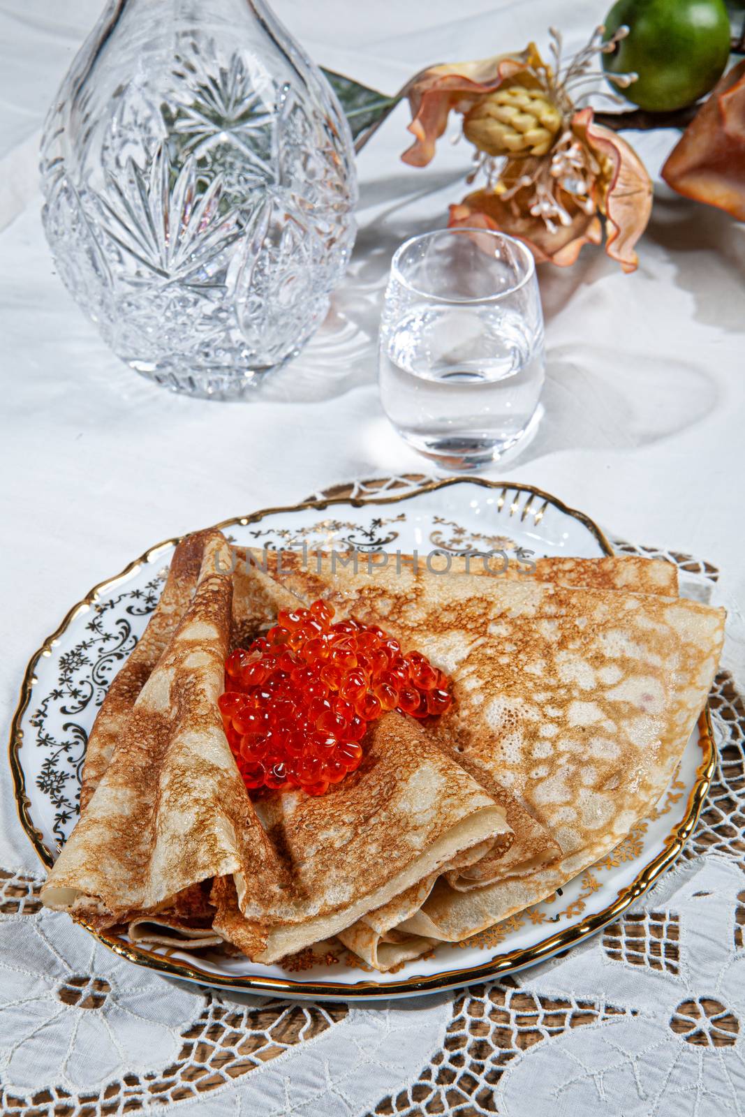 Pancakes and caviar on a canvas studio background