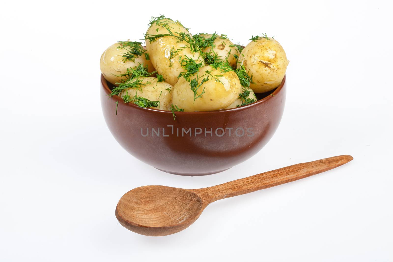 Potatoes, greenery and tableware on isolated satudio background