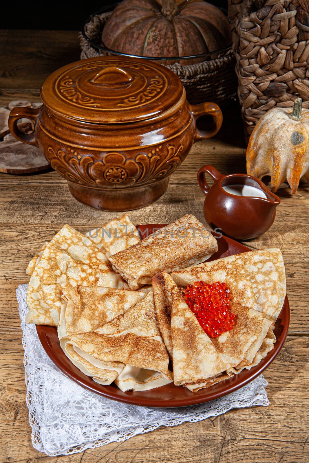 Pancakes and caviar on a canvas studio background