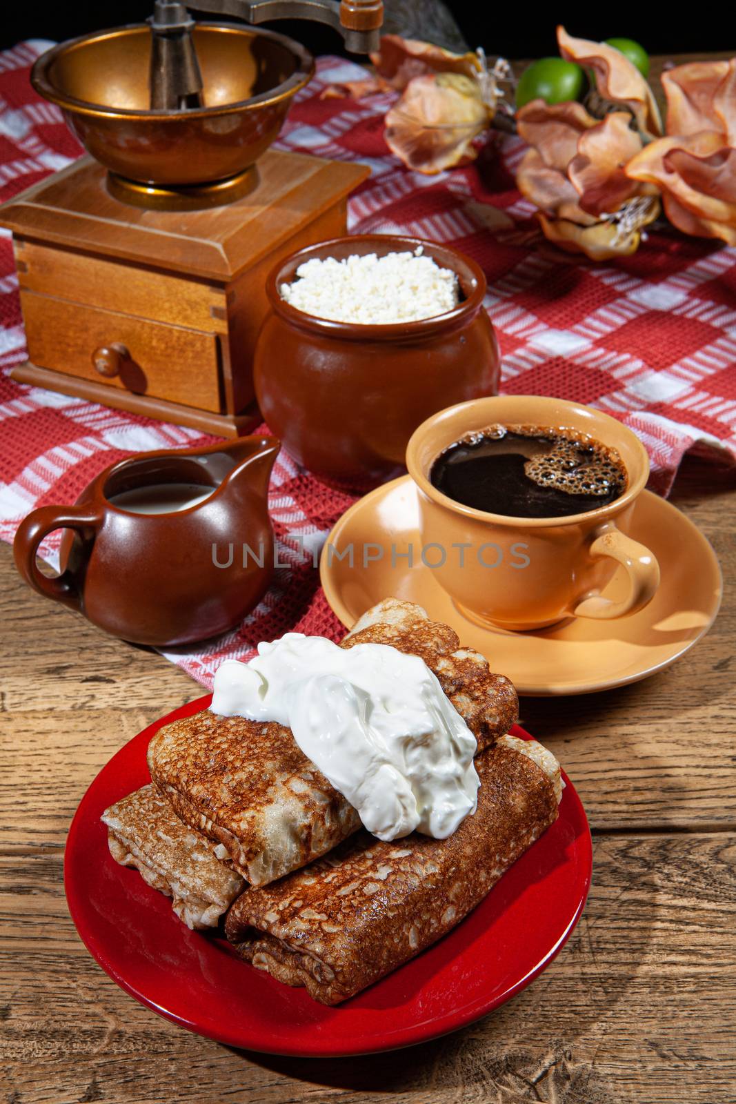 Pancakes and cream on a canvas studio background