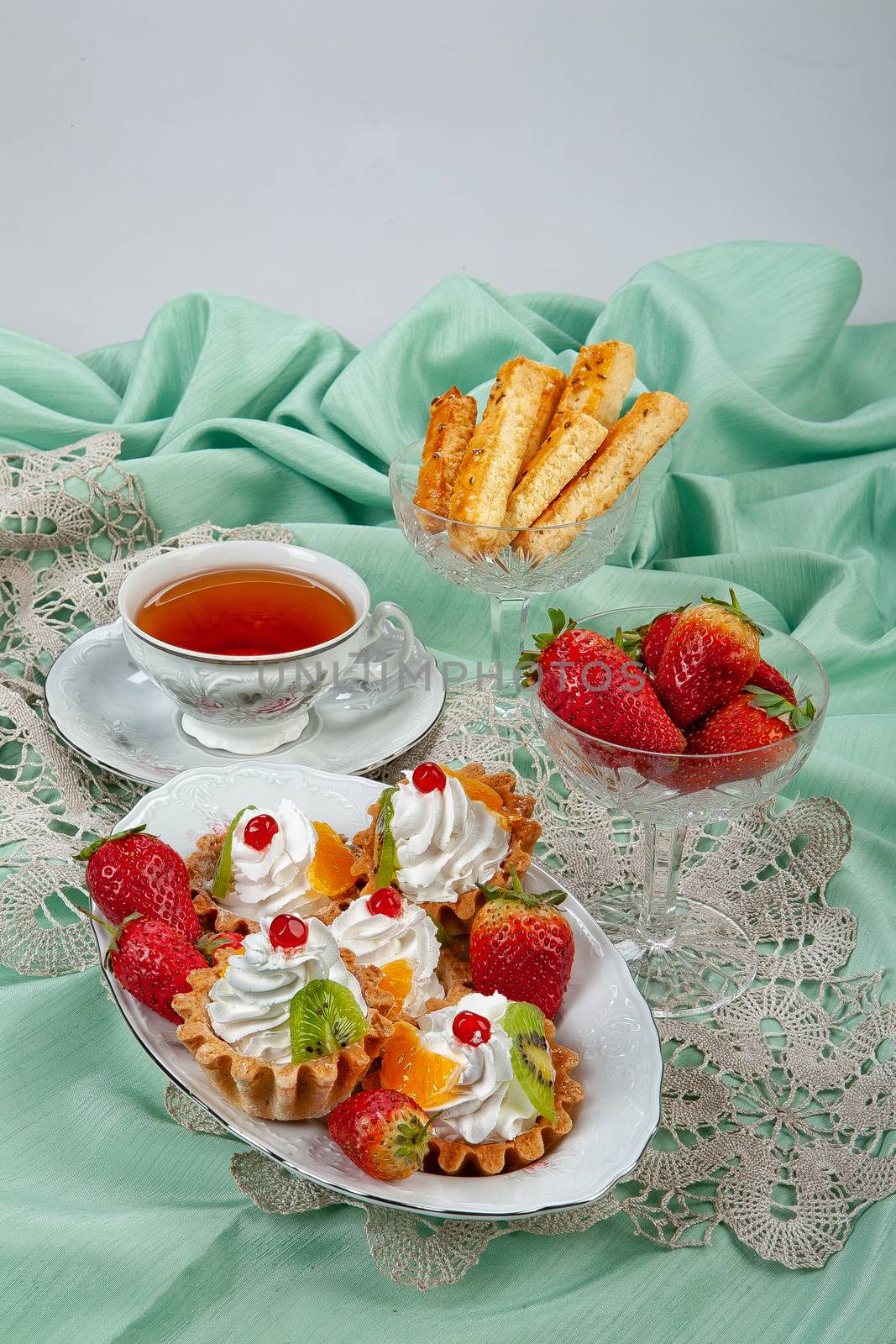 Still life with strawberries on a studio background