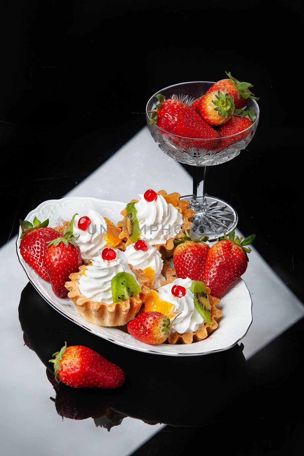 Still life with strawberries on a studio background