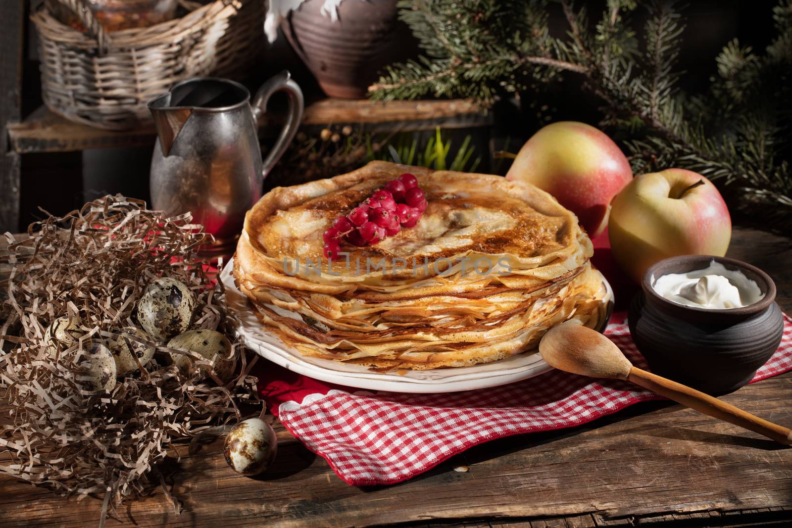 Plate with pancakes on an old wooden background