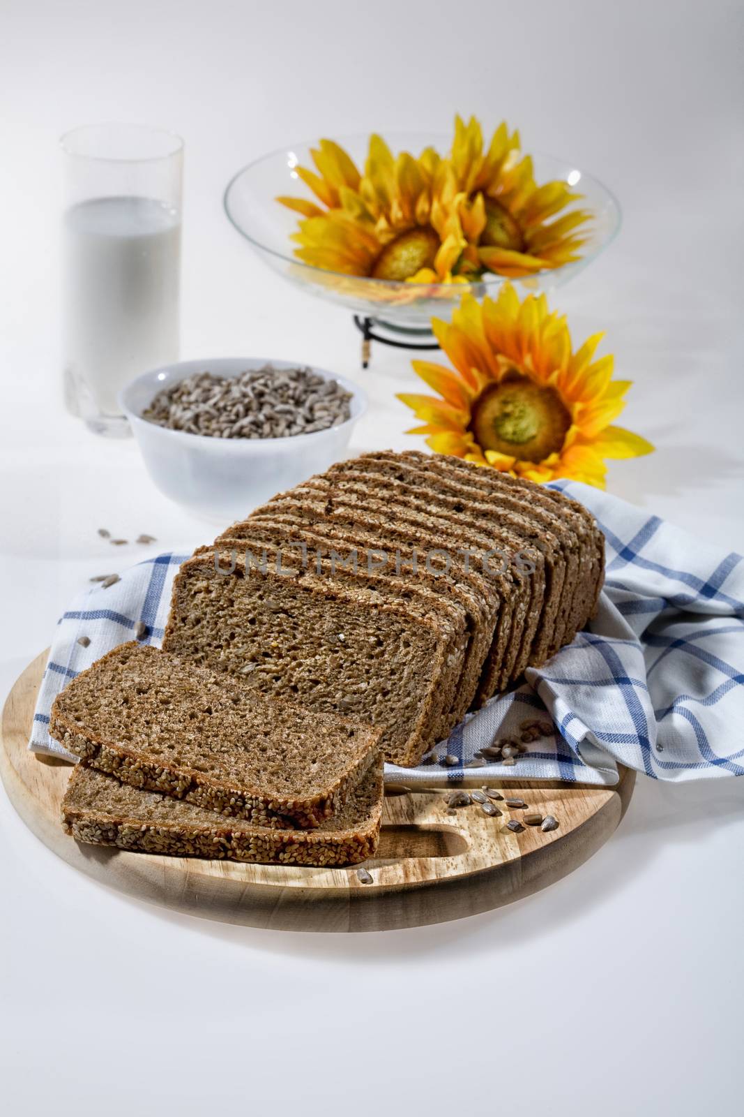 Pieces of bread, glass of milk and sunflower