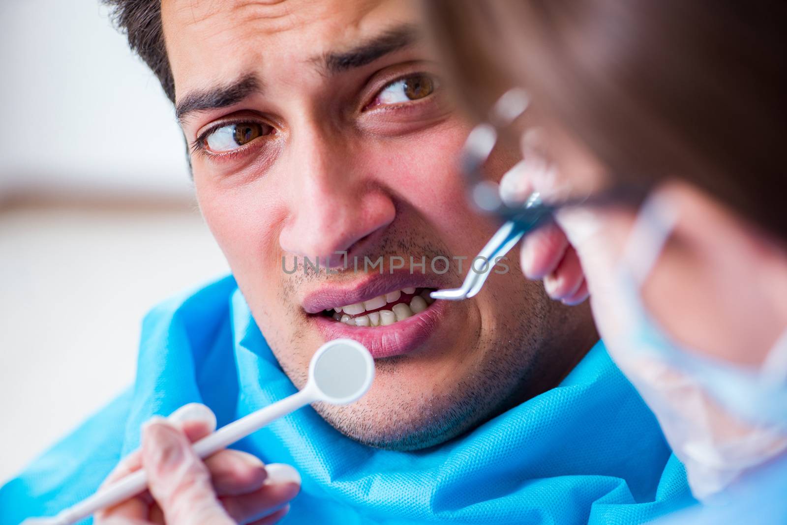 Patient afraid of dentist during doctor visit by Elnur