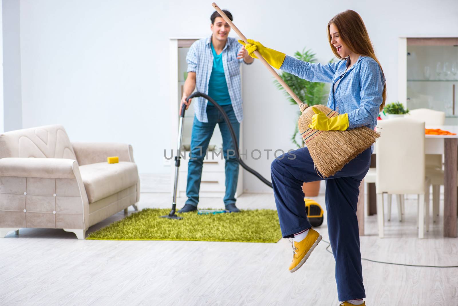 Young family cleaning the house