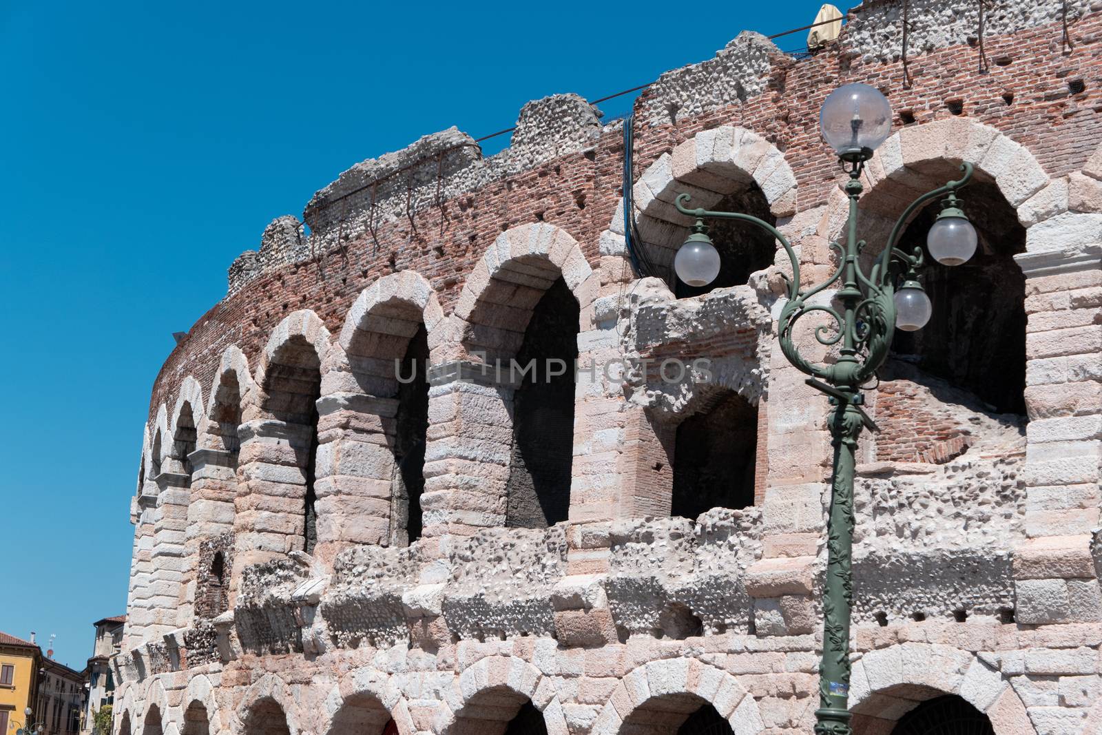 Verona, Veneto/Italy - 18.08.2020: The amphitheater in Verona with the sunken outer ring and a street