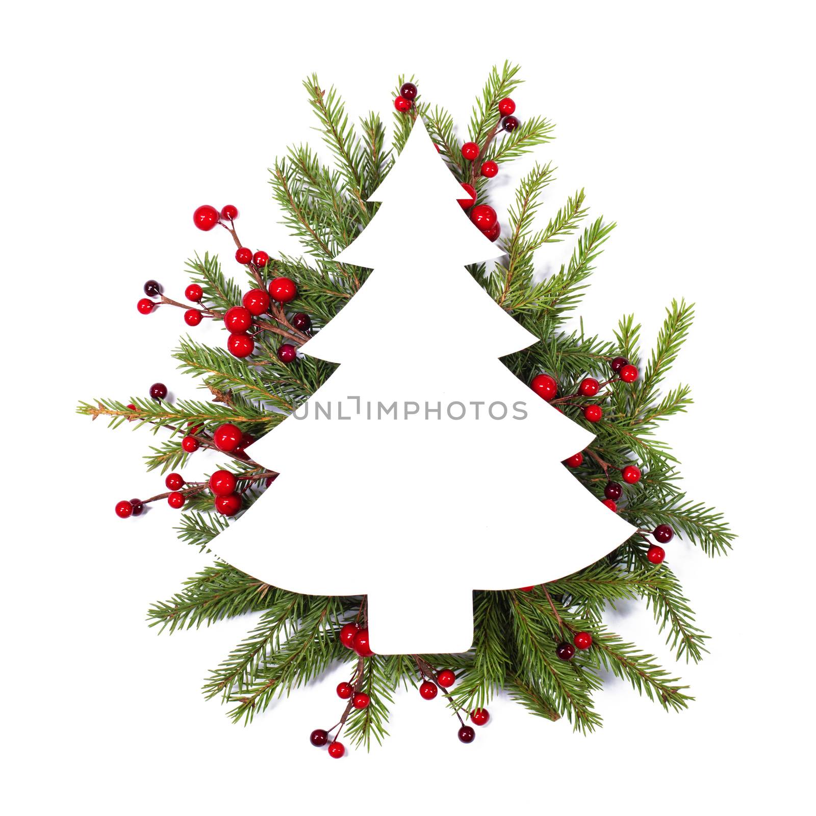 Christmas white fir tree shaped blank card with copy space and decor of fir tree branch red holly berry isolated on white background