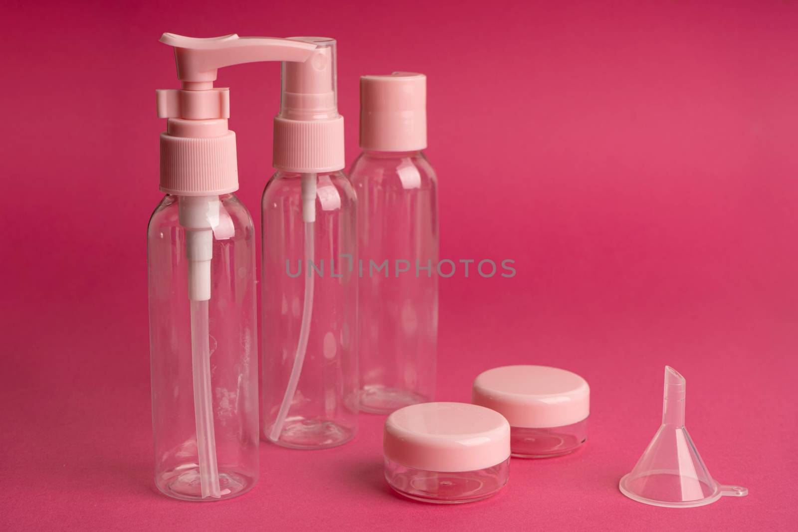 A kit of plastic containers for transportation of shampoos, creams and cosmetics in travel.