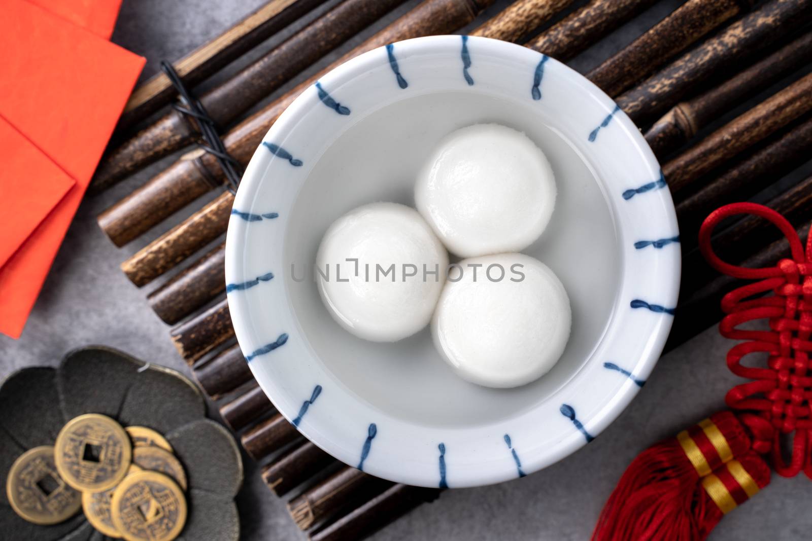 Top view of big tangyuan yuanxiao (glutinous rice dumpling balls) for lunar new year festival food, words on the golden coin means the Dynasty name it made.