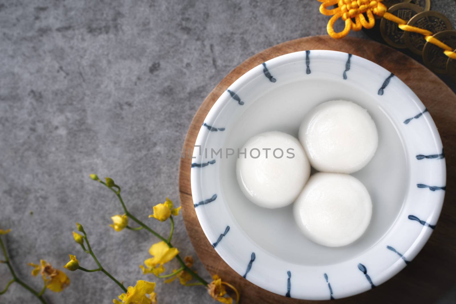Top view of big tangyuan yuanxiao (glutinous rice dumpling balls) for lunar new year festival food, words on the golden coin means the Dynasty name it made.