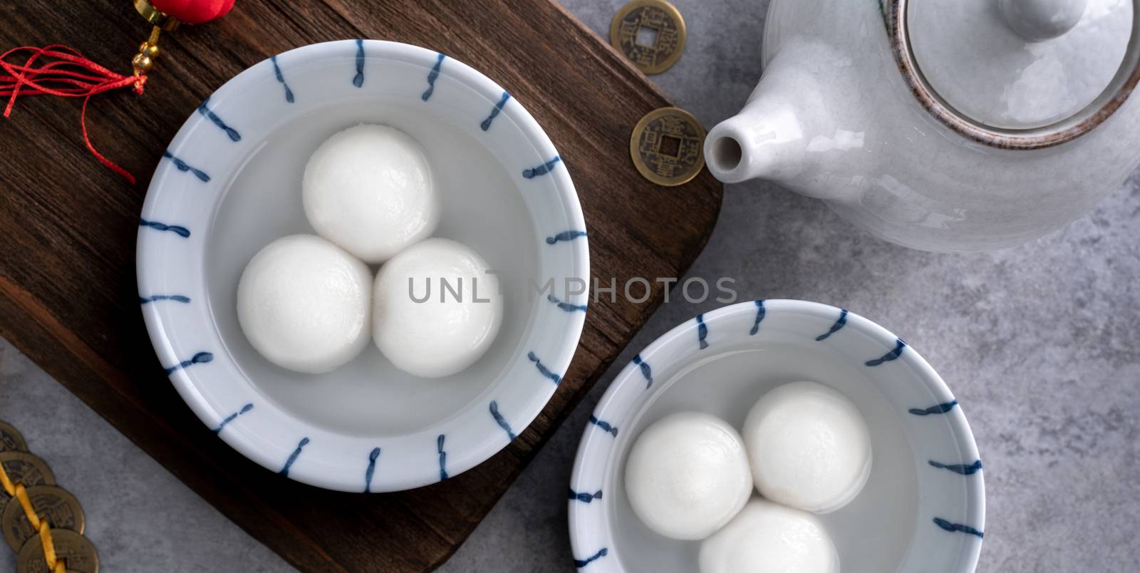 Top view of big tangyuan yuanxiao (glutinous rice dumpling balls) for lunar new year festival food, words on the golden coin means the Dynasty name it made.