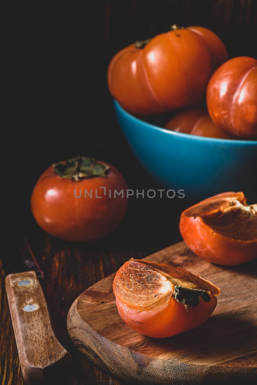 Slices of fresh persimmon on cutting board