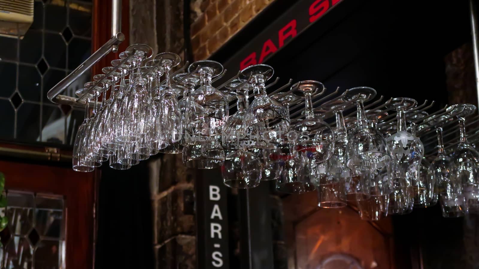 Stacked glasses for drinks in a bar. Glasses in a restaurant. Bar empty glasses. by codrinn