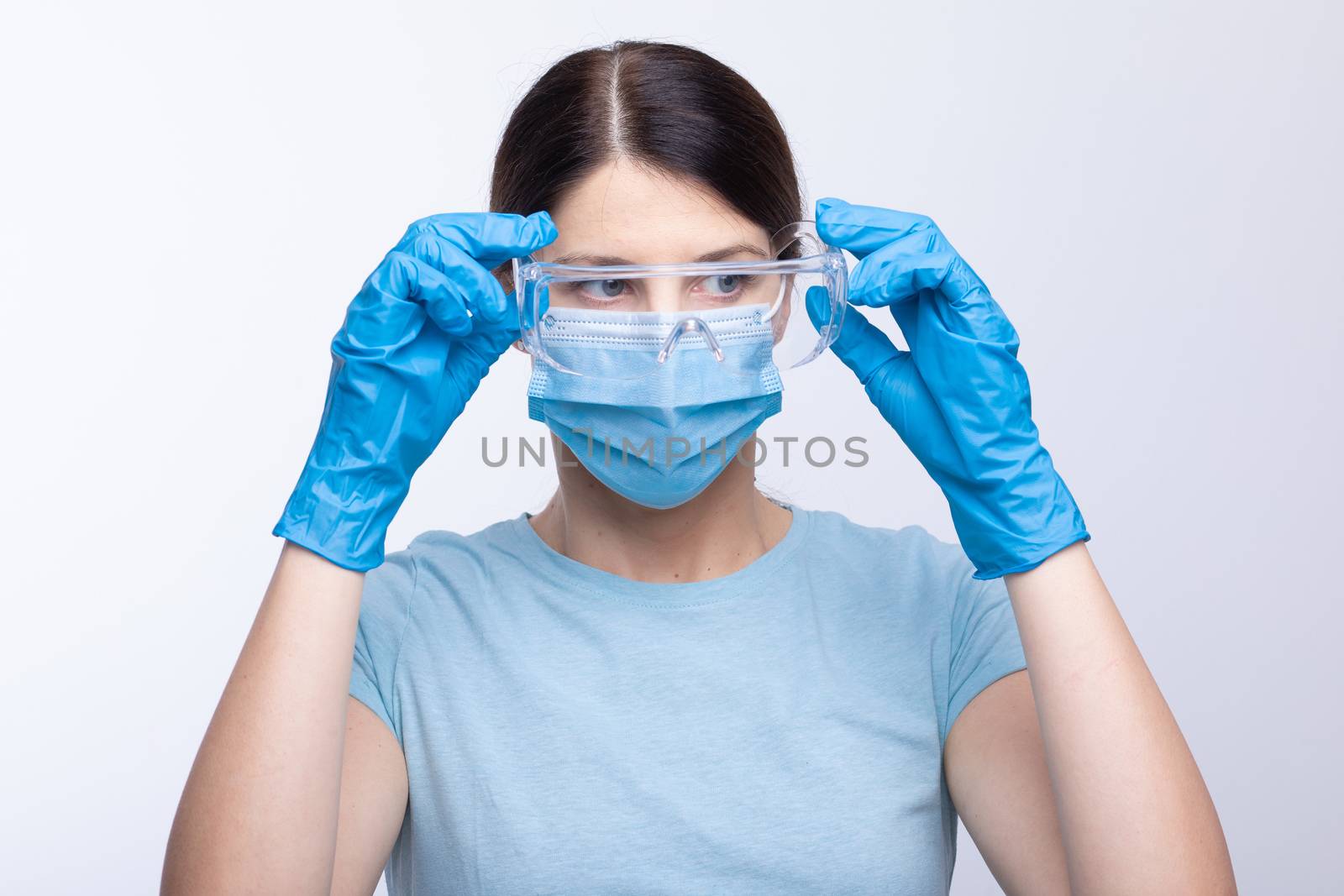 Nurse or doctor wearing and checking protective equipment against viruses and bacterial disease stock photo