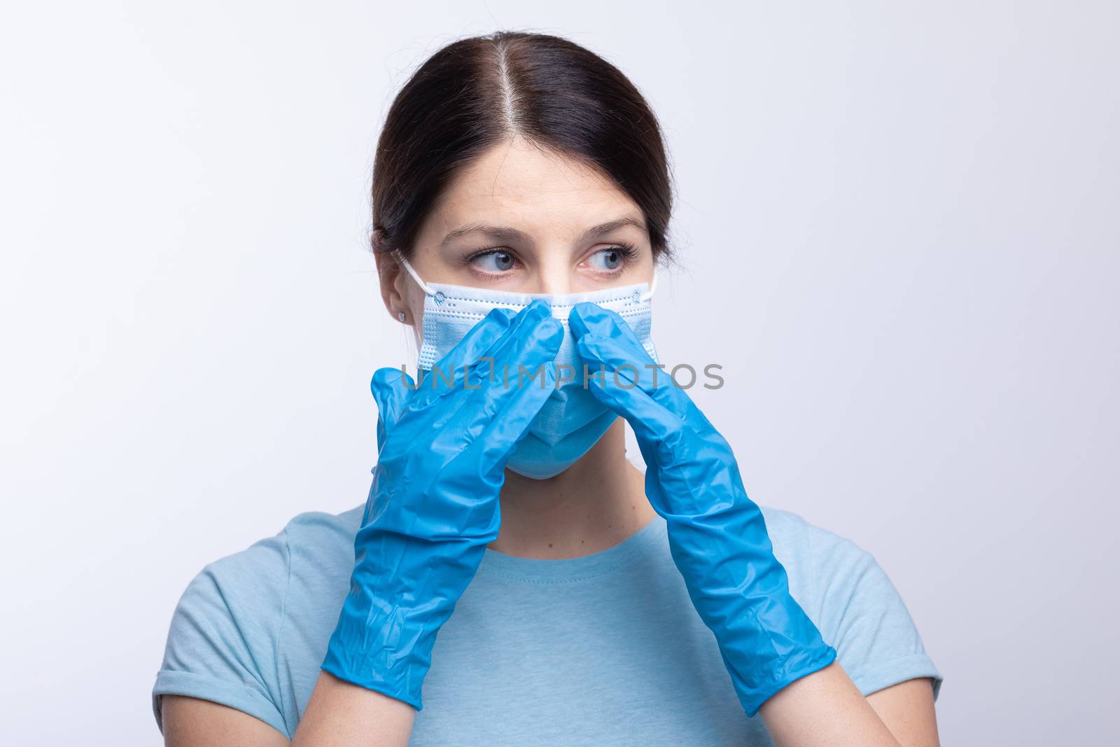 Nurse or doctor wearing and checking protective equipment against viruses and bacterial disease stock photo