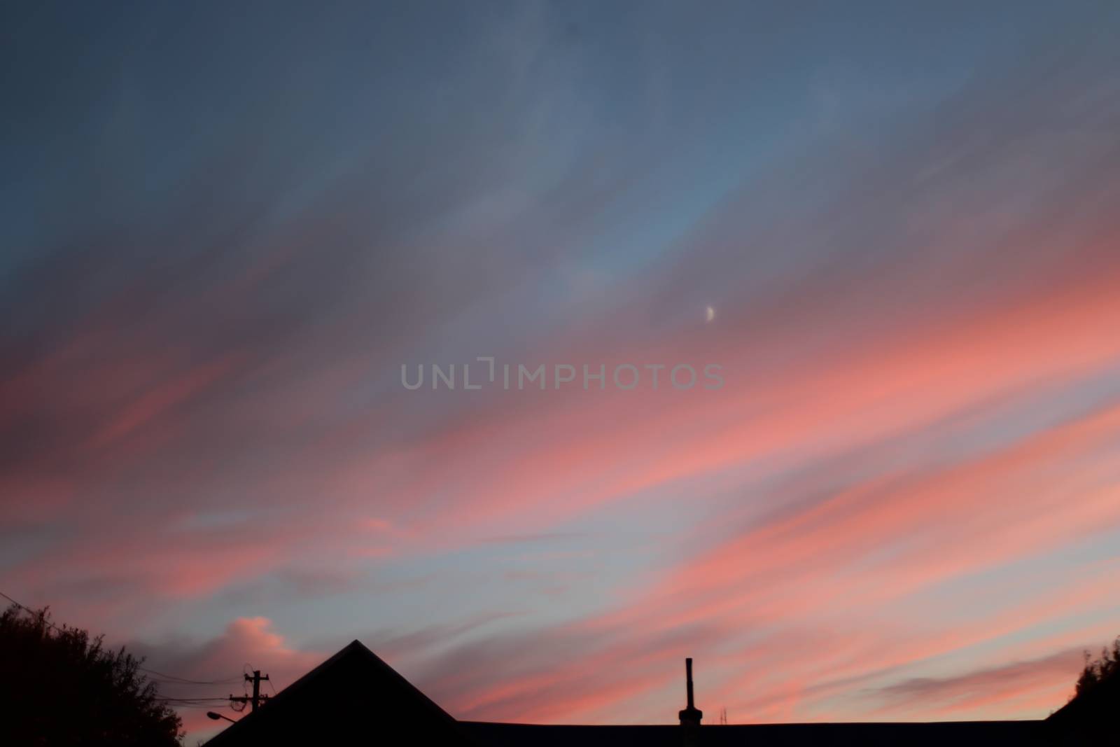 Fire sunset with hazy clouds and house