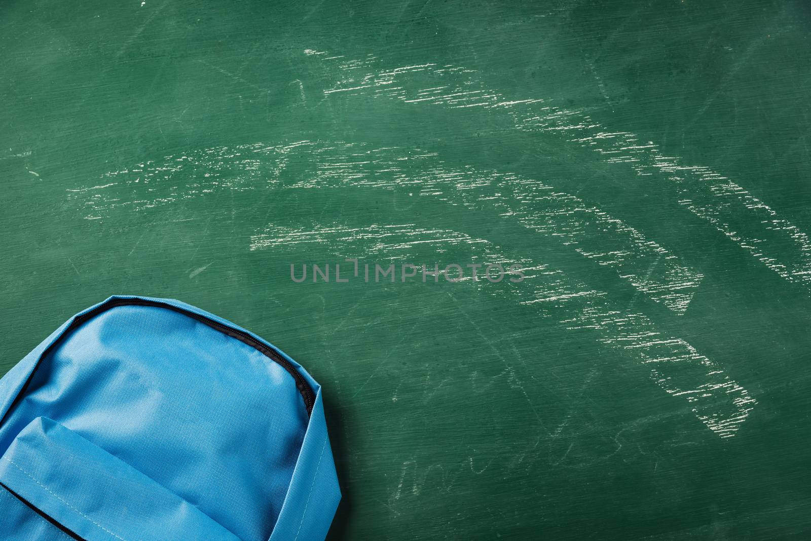 school bag backpack at a green chalkboard by Sorapop