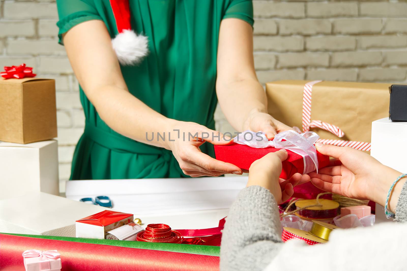 women hands holding and giving red gift box with white ribbon. Birthday, Christmas, Mother's day and New year present box