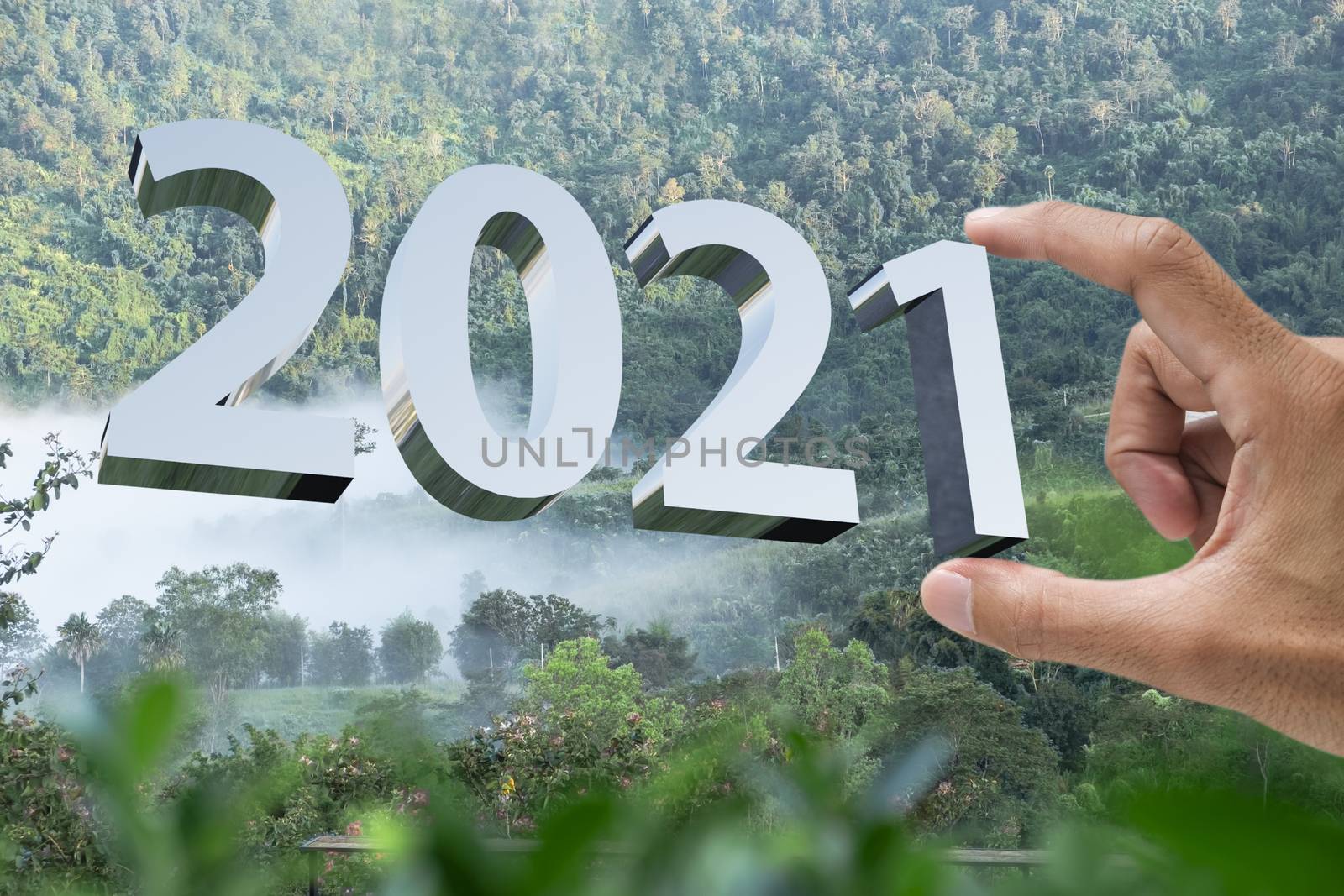 People man hand holding numbers 2021 Metaphor In the new year 2021 festival With scenic scenery In the forest Mountain and fog of Khao Kho Phetchabun Thailand Count down change 2020 to 2021 year