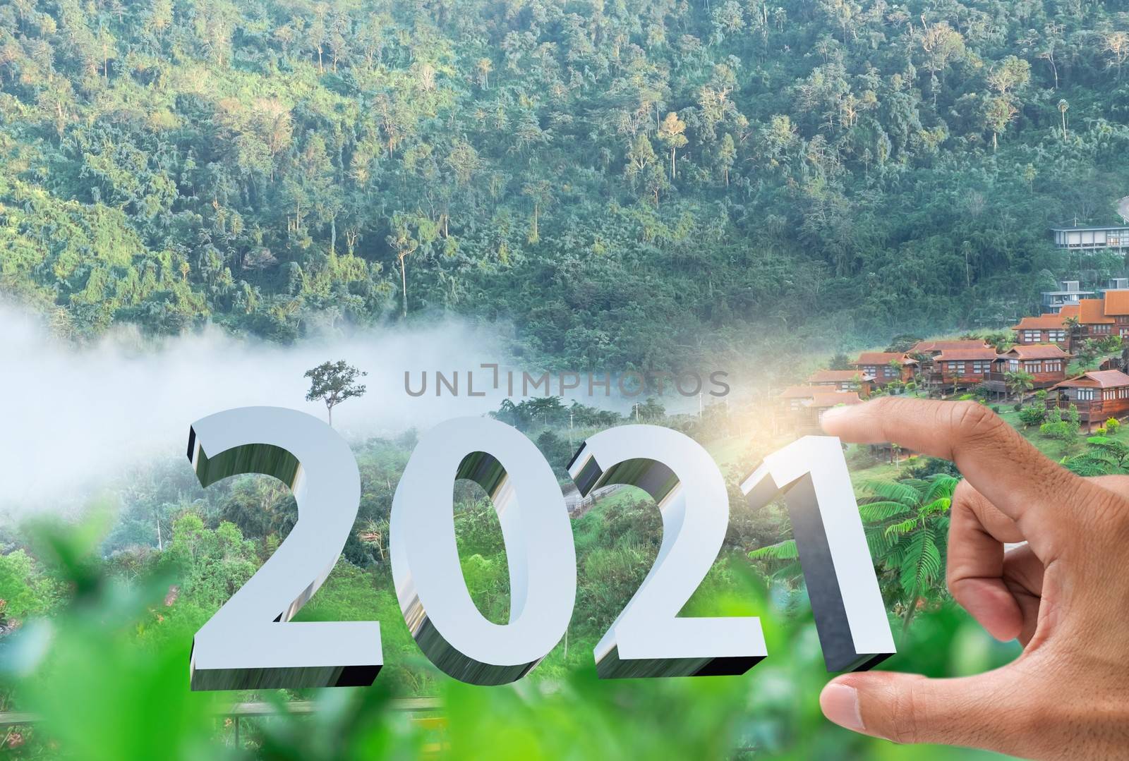 People man hand holding numbers 2021 Metaphor In the new year 2021 festival With scenic scenery In the forest Mountain and fog of Khao Kho Phetchabun Thailand Count down change 2020 to 2021 year