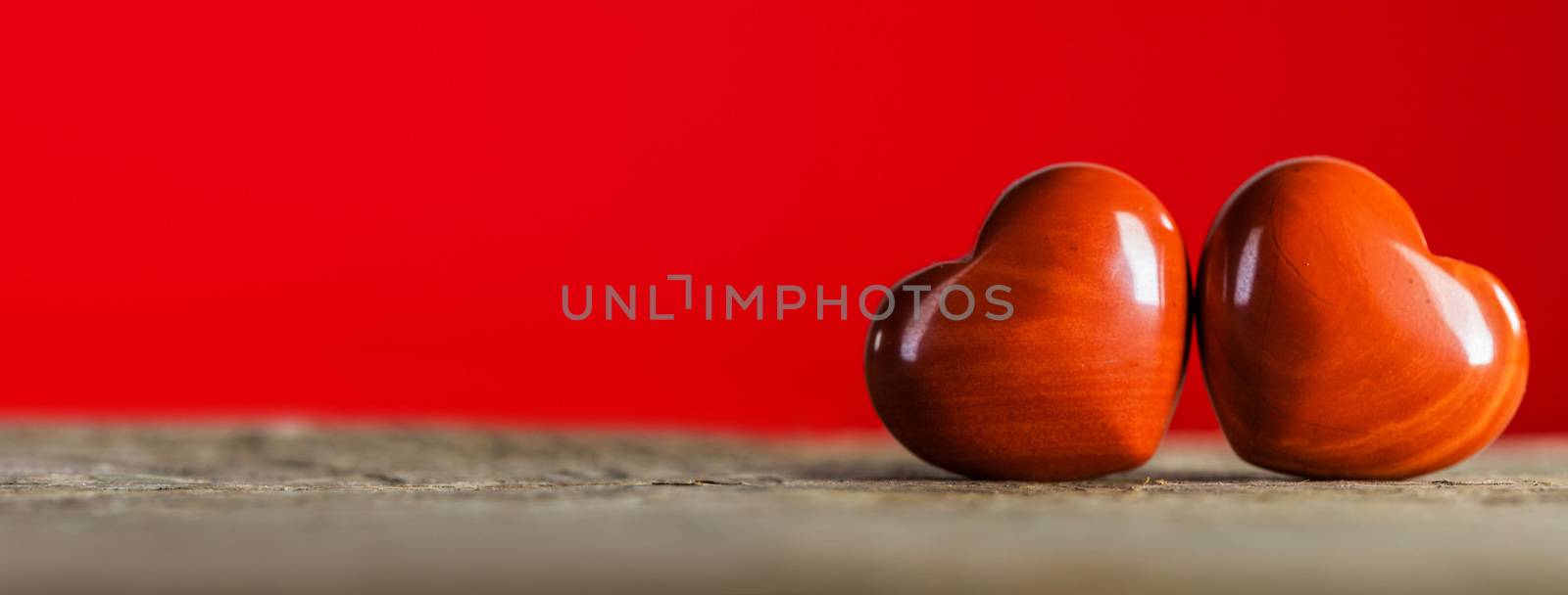 Valentine's day two red hearts on wooden background, love concept
