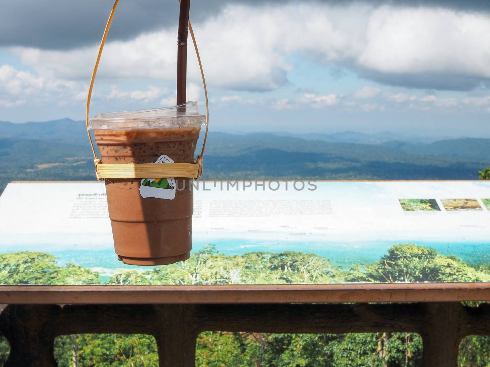 A glass of Thai tea on a mountain background in Khao Yai National Park