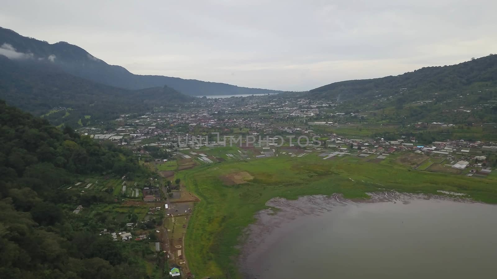 Beatiful aerial drone view over the lake. Lake and mountain view from a hill, Buyan Lake, Bali.